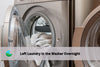 wahsing machine open with laundry hanging out. the laundry was there all night and made it smelly